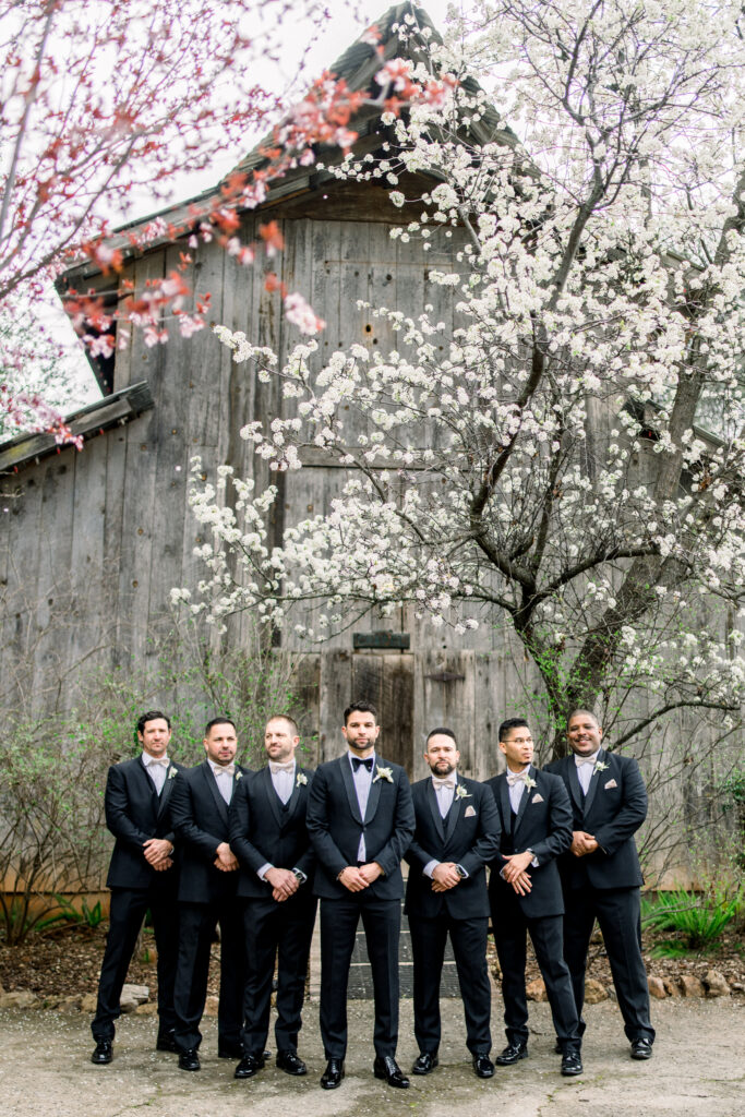 Groom and wedding party infant of California barn chapel at Union Hill Inn in Sonora, CA Image by Tiffany Longeway Photography