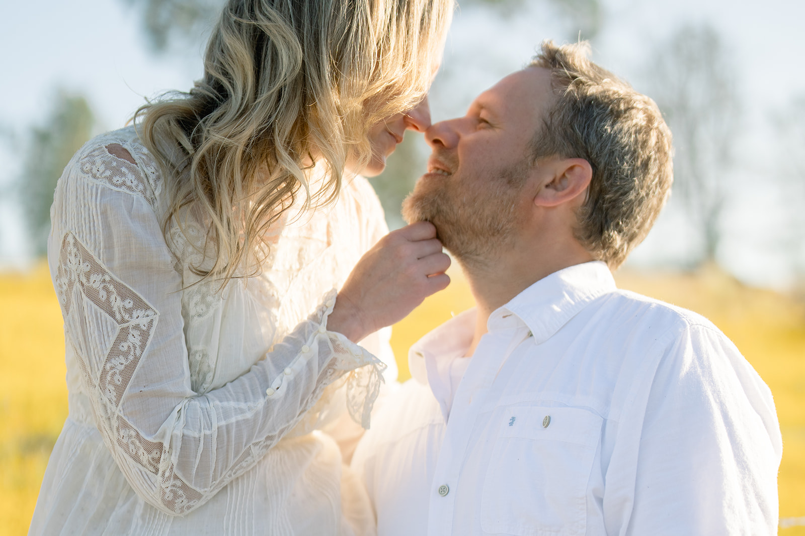 Heather and Ryan share a tender moment during their Northern California engagement session, with golden sunlight illuminating their faces.