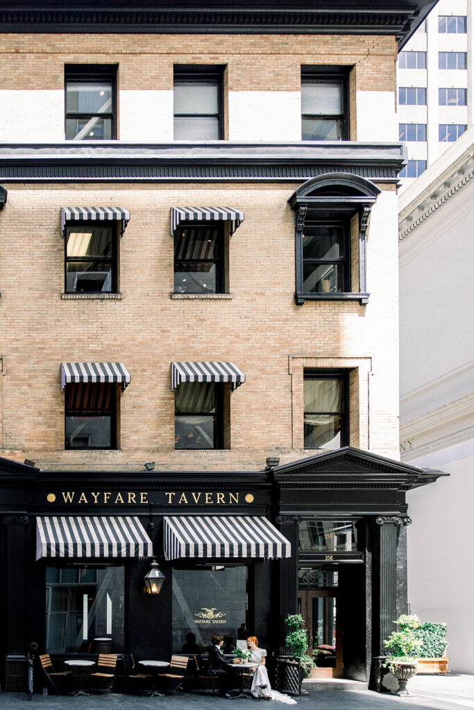 Bride and Groom outside the Wayfare Tavern, a historic and stylish venue option for a San Francisco wedding reception.