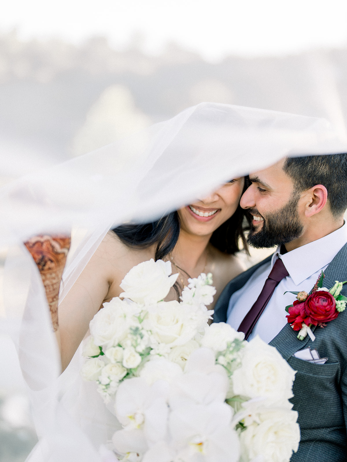 Golden hour wedding portrait with a backlit veil at a waterfall at Monserate Winery
